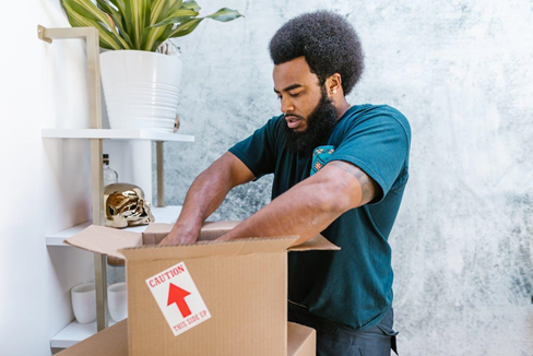  Mover packing up a moving box